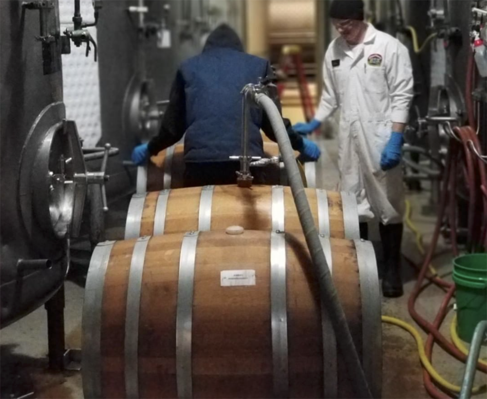 Ben Carignan rinsing barrels