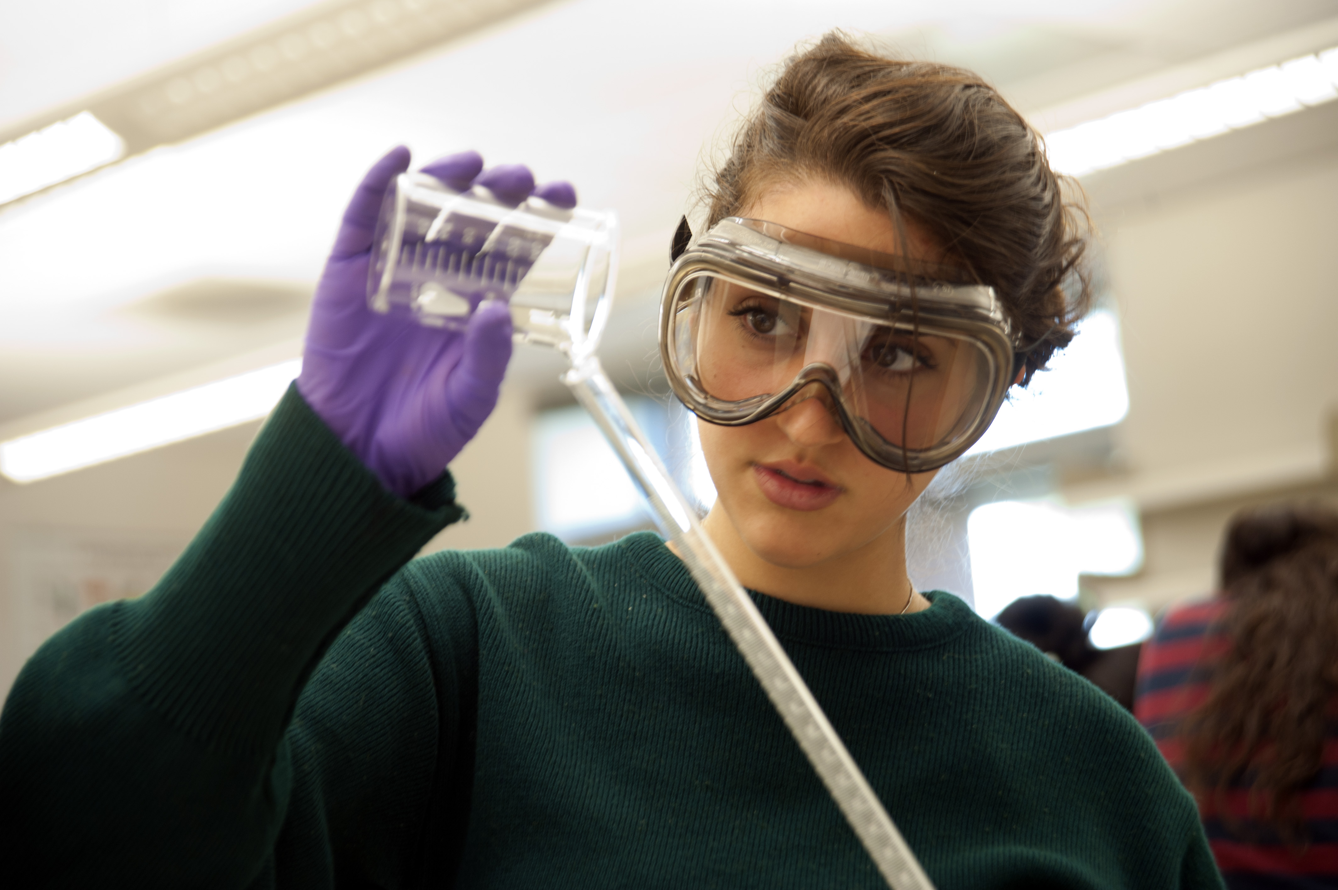 student in lab with safety goggles