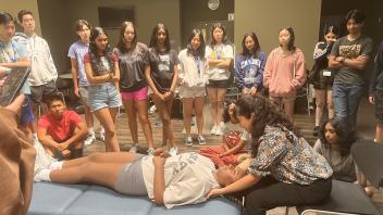 UC Davis Pre-College Pre-Med students watch a demonstration by a guest speaker