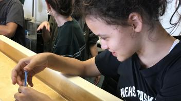 UC Davis Pre-College student extracts eggs from a sea star in the lab