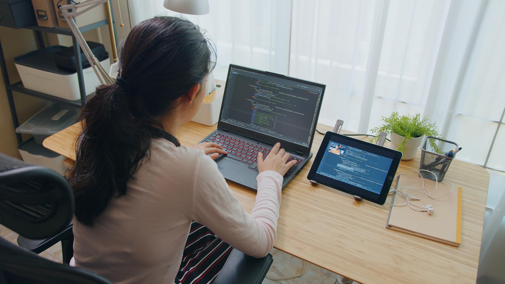 young woman working on computer code
