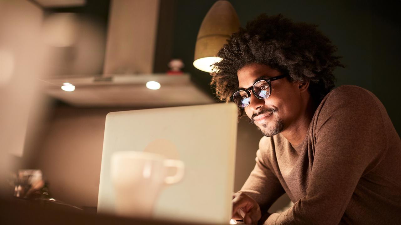 young professional at home on computer