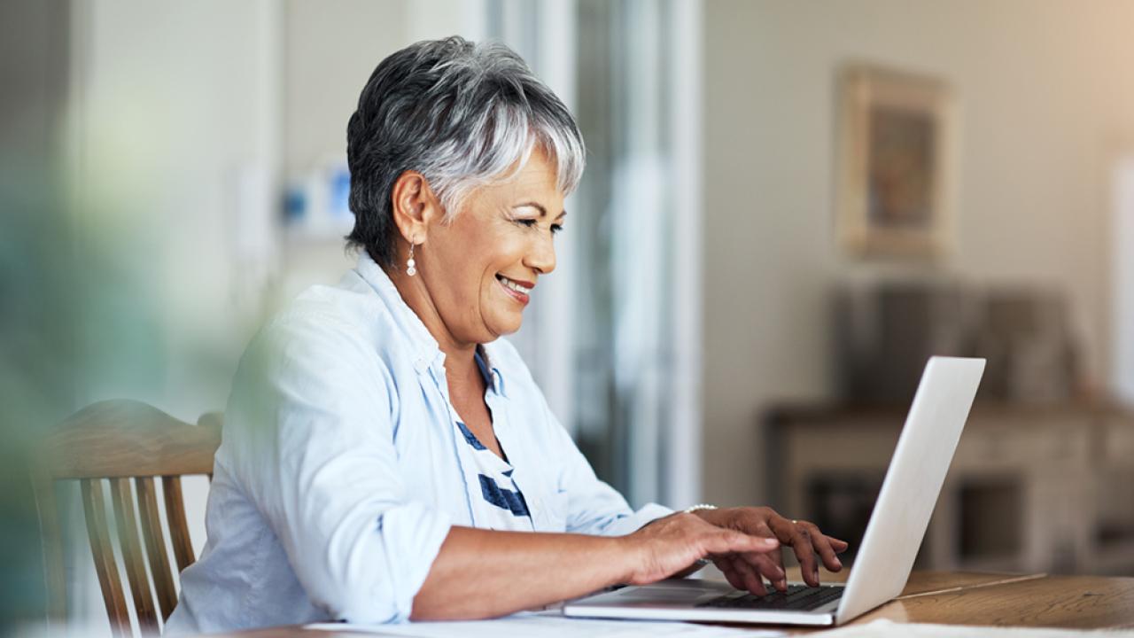 smiling senior woman on a laptop at home