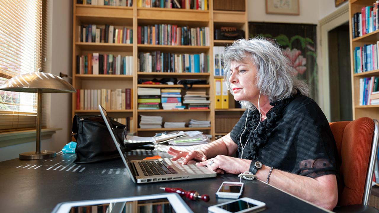 senior woman working on a laptop at a desk