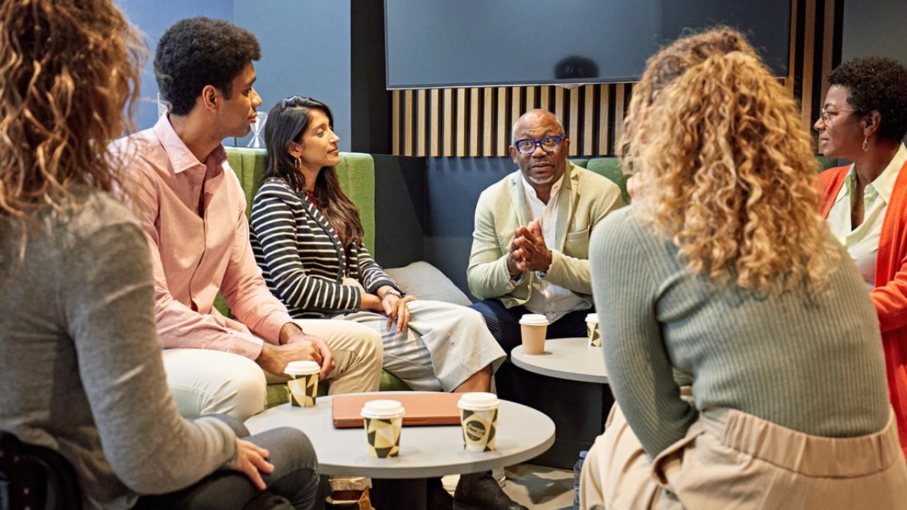diverse team of business professionals have an informal meeting with coffee