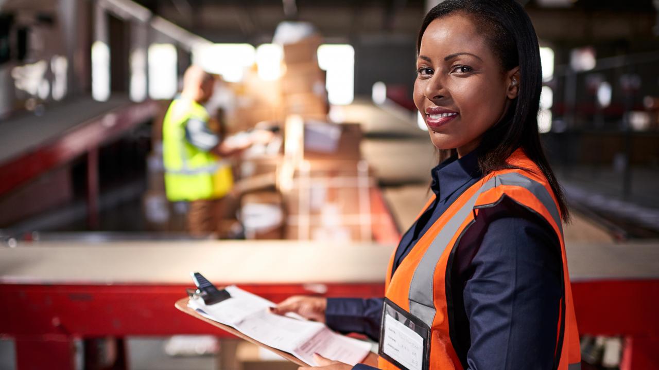 femal OHS worker with clipboard