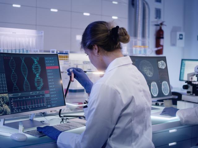 scientists studying DNA models in a research lab