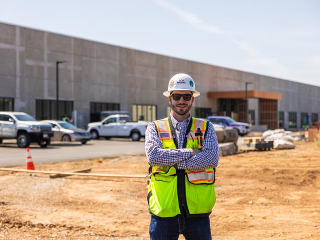 UC Davis Construction Management grad, Jon Davis, poses in front of a construction site