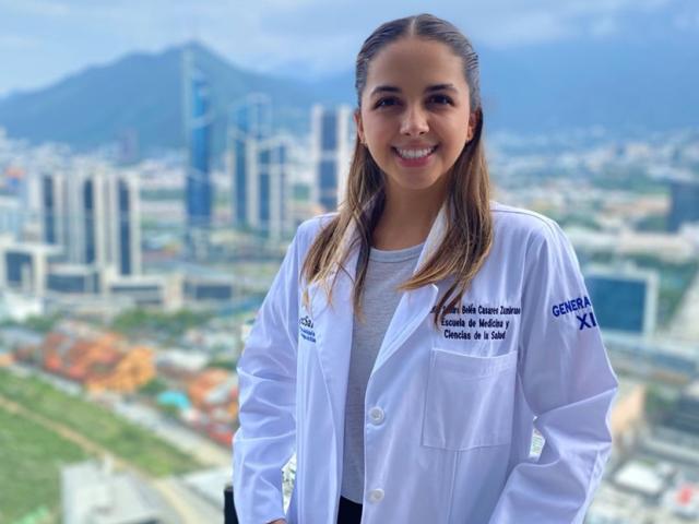 maternal and child nutrition master's student, Sandy Casares, poses with medical coat on