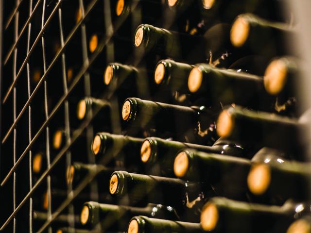 close up of wine bottles on shelf