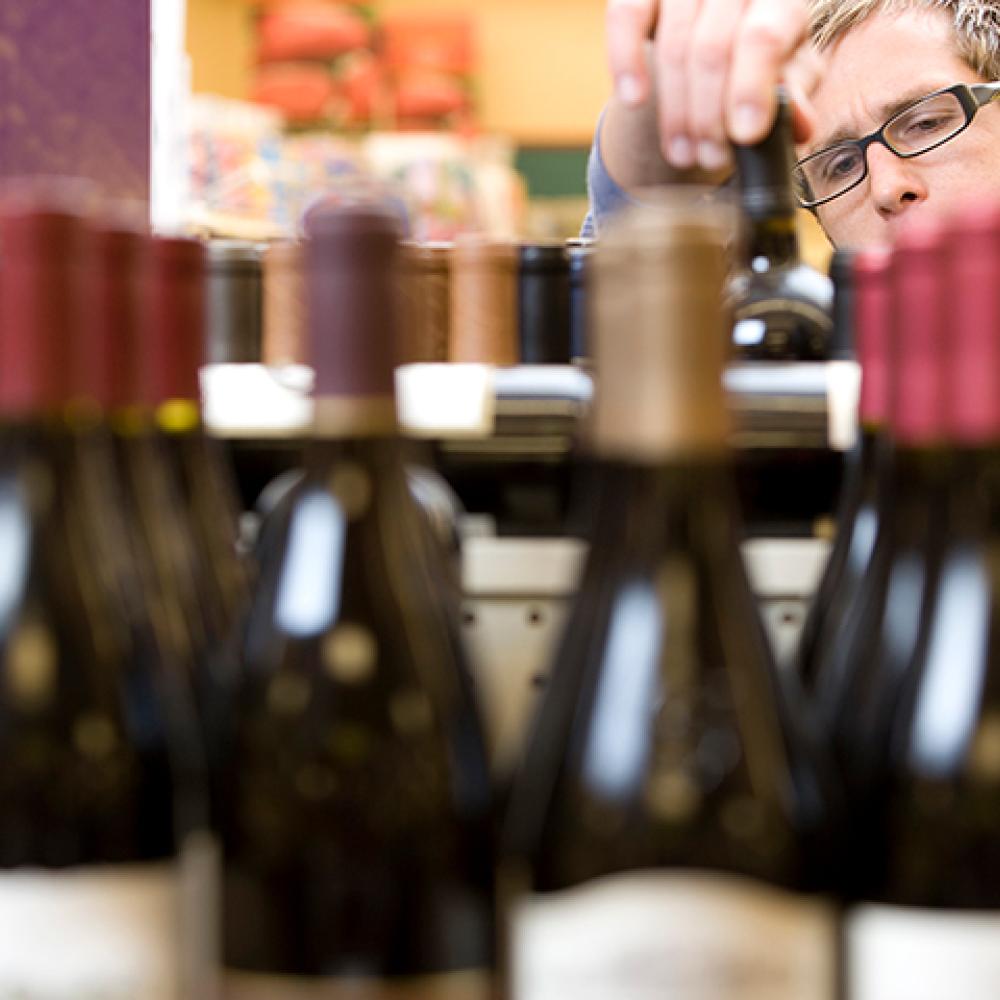 man shopping for wine in a store