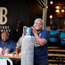 Tapping Potential Scholarship winner Chijindu Onwuchekwa poses with keg