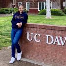maternal and child nutrition master's student, Stefany Cinco, poses in front of UC Davis sign