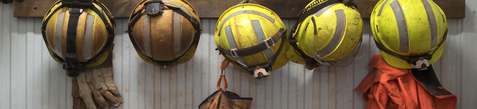 hard hats hanging on a wall