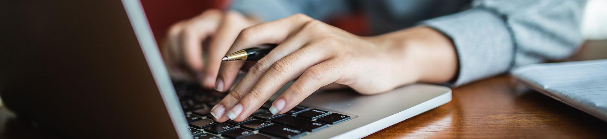 woman typing on a laptop computer