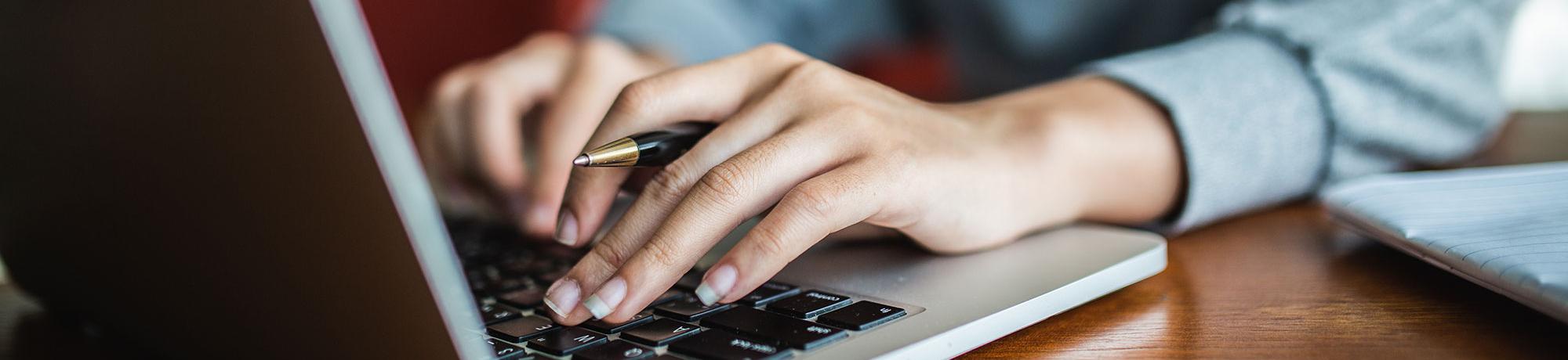 woman typing on laptop