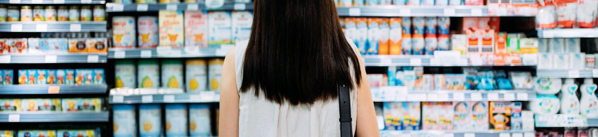 woman shopper looking at wall of products