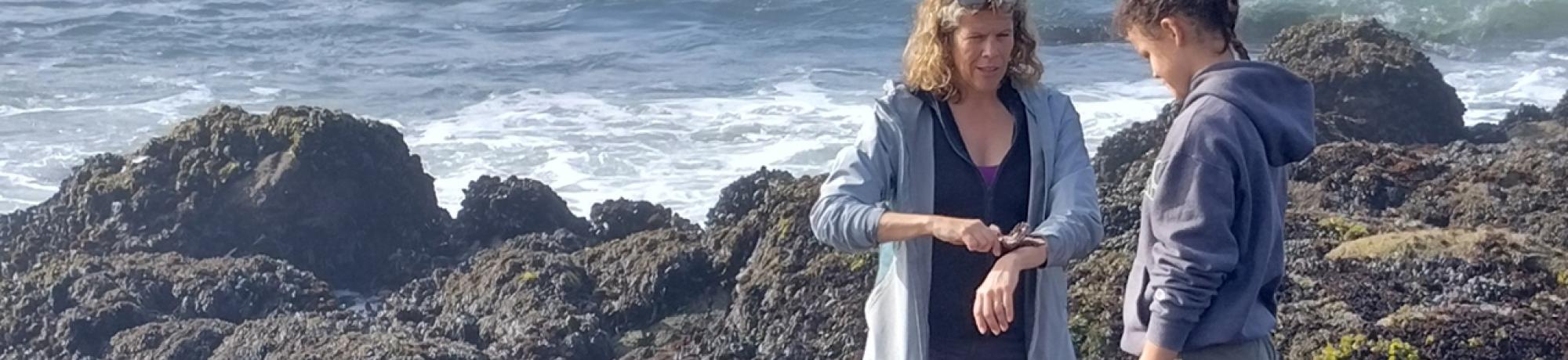 UC Davis professor Ellie Fairbairn and a UC Davis Pre-College student explore the tidal pools at Bodega Bay Reserve