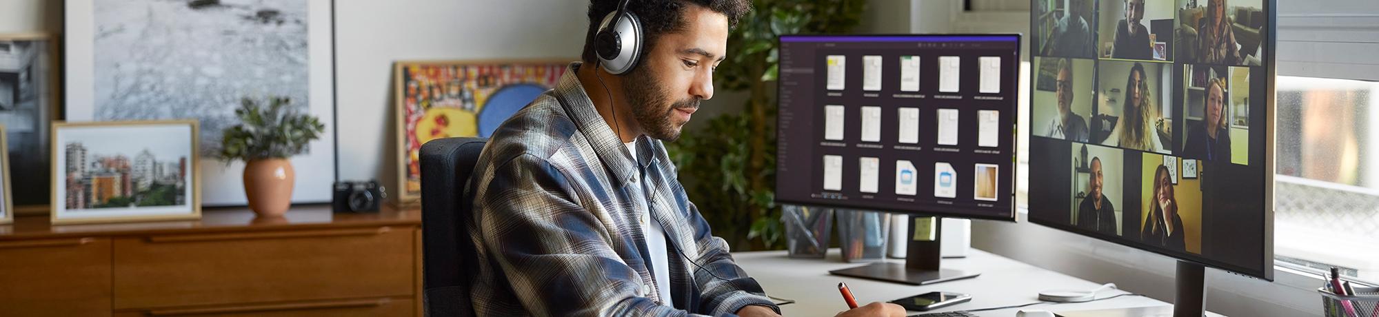 man wearing headphones participating in an online video meeting