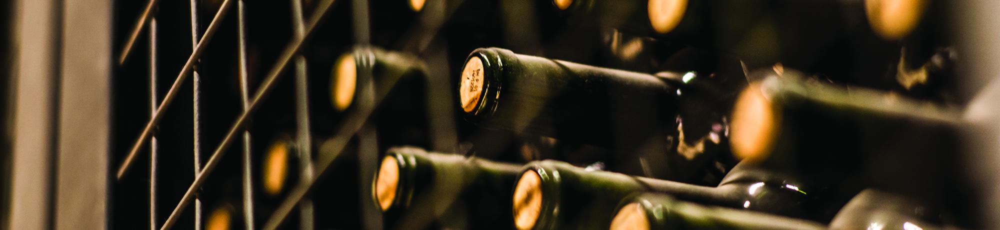 close up of wine bottles on shelf